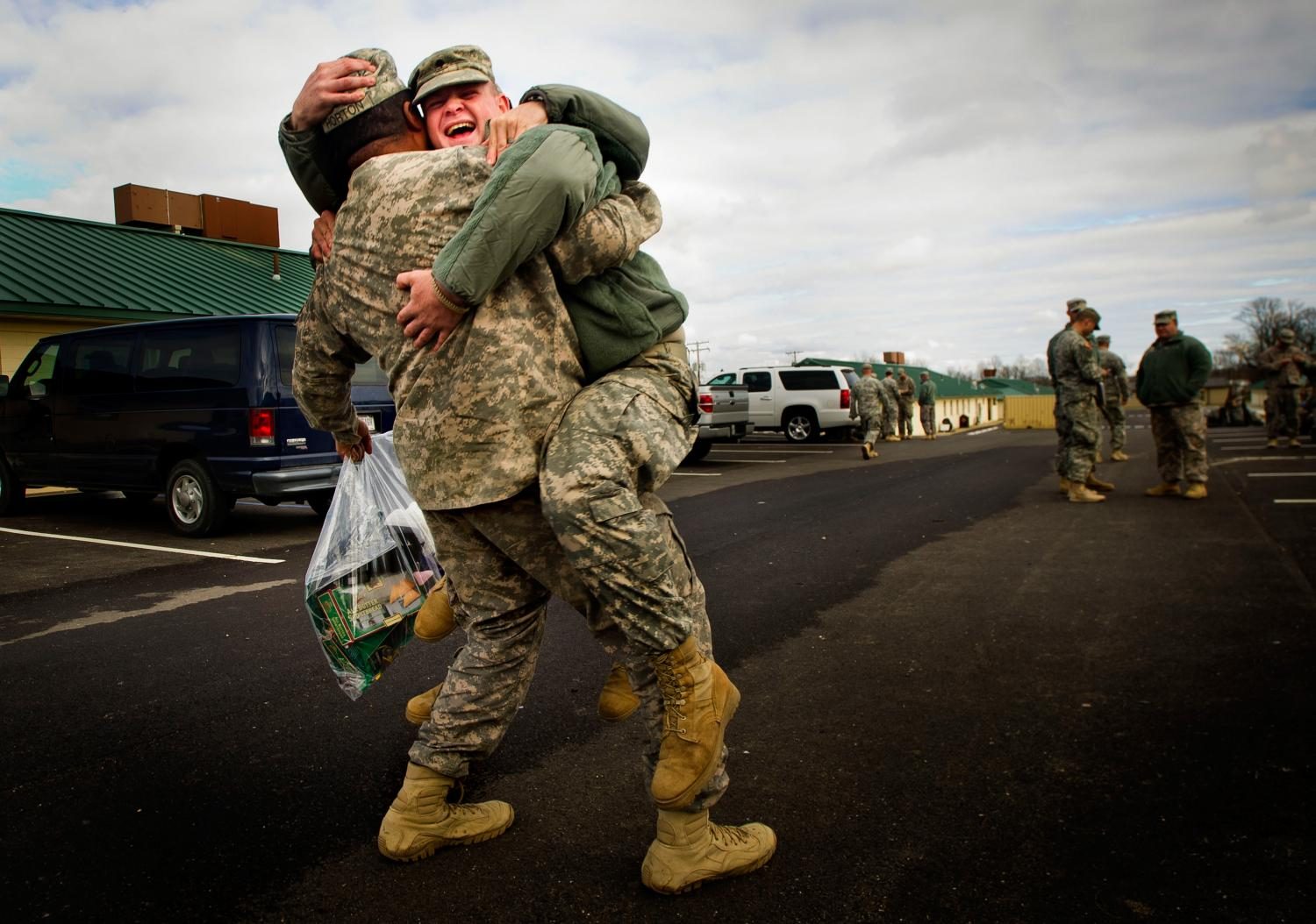 Two service members embrace during an emotional reunion.